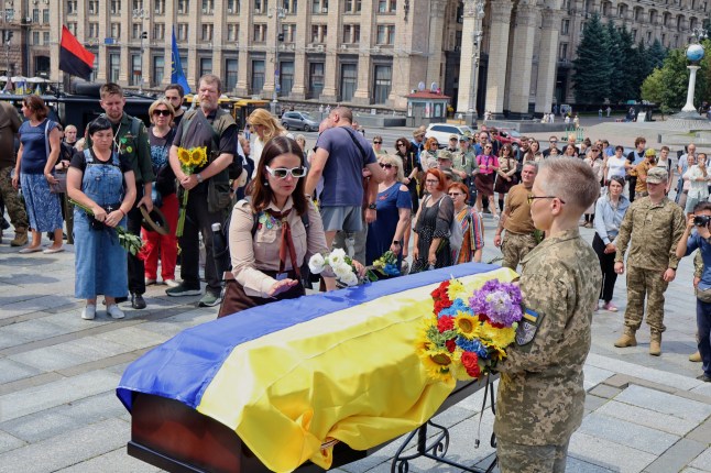 KYIV, UKRAINE - JULY 9: Members of Plast, the Ukrainian scouting organization, bid farewell to their leader Roman Onyshchenko on July 9, 2025 in Kyiv, Kyiv Oblast, Ukraine. Funeral ceremony for Ukrainian Armed Forces officer Roman Onyshchenko. He was a company commander in the 72nd Mechanized Brigade named after the Black Cossacks. He was also one of the key figures in the national scout organization "Plast." The soldier was killed on July 2, 2025, as a result of a Russian guided bomb strike. He is survived by his wife and two children. (Photo by Andriy Zhygailo/Oboz.ua/Global Images Ukraine via Getty Images)