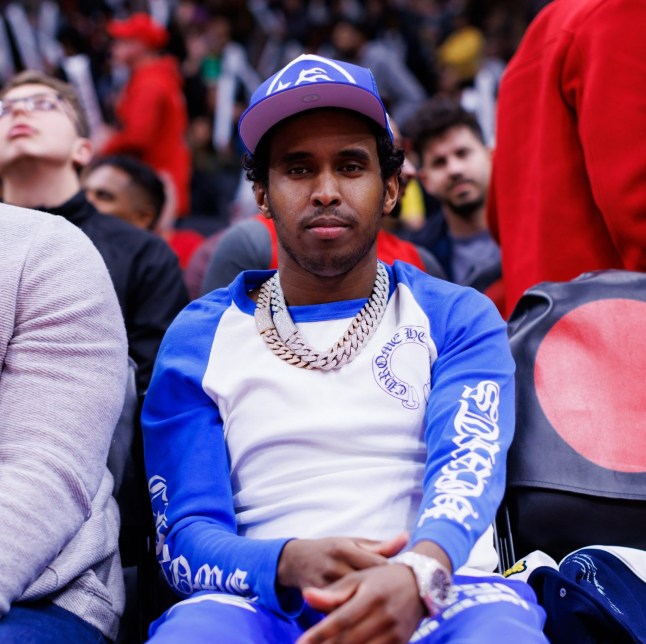 TORONTO, CANADA - OCTOBER 28: Toronto rapper Hassan Ali, aka Top5 during the second half of their NBA game against the Denver Nuggets at Scotiabank Arena on October 28, 2024 in Toronto, Ontario, Canada. NOTE TO USER: User expressly acknowledges and agrees that, by downloading and or using this photograph, User is consenting to the terms and conditions of the Getty Images License Agreement. (Photo by Cole Burston/Getty Images)