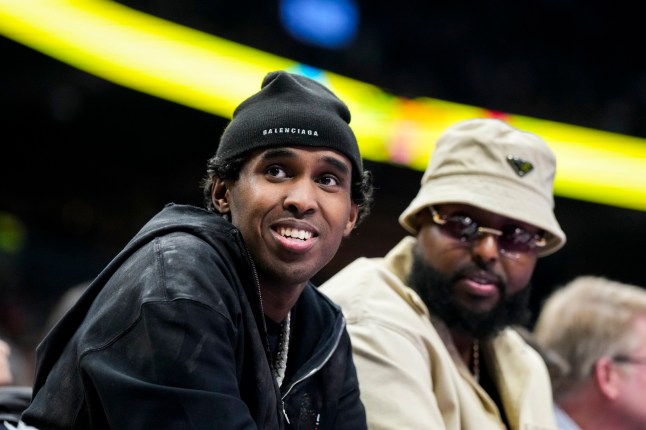 Local rapper Top5 looks on from the courtside at a NBA between the Indiana Pacers and Toronto Raptors