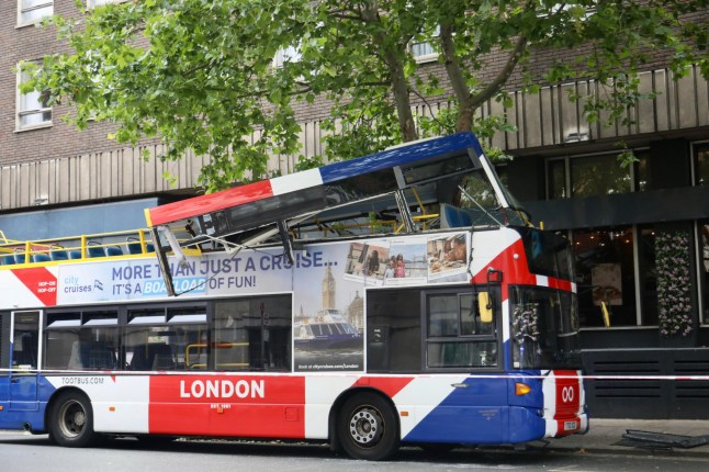 A hop-on hop-off London tour bus packed with tourists has crashed in central London, just yards from the historic 7/7 bomb site, injuring several people and triggering a major emergency response. The collision occurred at around 2:40pm this afternoon, when the open-top double-decker bus struck a tree during a sightseeing route near Tavistock Square. The force of the impact crumpled the roof of the upper deck, trapping at least six people, including a young girl, inside the mangled wreckage. Emergency Services Rush to the Scene Multiple fire engines, ambulances, and paramedic units from the London Ambulance Service and London Fire Brigade rushed to the scene. Firefighters used specialist cutting tools to free the trapped passengers, working urgently to secure the damaged upper deck. Witnesses described scenes of ???carnage onboard???, with the bus suddenly jolting and a loud bang echoing across the area. ???I thought a bomb had gone off,??? said one nearby shop worker. ???The noise was horrific ??? metal twisting, glass shattering ??? total chaos. Then people started screaming.??? Location: Near Tavistock Square The crash occurred near Tavistock Square, the site of the devastating 2005 London bus bombing, heightening alarm among those nearby. Police quickly cordoned off the area, reassuring the public that this incident was unrelated to terrorism. Sightseeing Tour Turns to Panic The bus was part of a Hop-on Hop-off sightseeing tour, popular with visitors wanting to explore iconic landmarks at their own pace. It is understood the vehicle collided with a low-hanging tree while in motion, causing catastrophic damage to the roof section. The London Fire Brigade confirmed that the vehicle was made safe shortly after the incident. ??Investigation Underway The Metropolitan Police???s Commercial Vehicle Unit, along with Roads and Transport Policing Command, has launched an investigation into the cause of the crash. Engineers are examining the bus, and CCTV fo