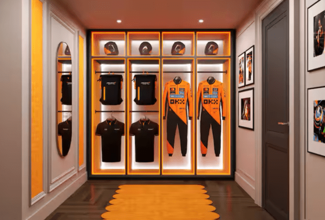 A wall at the McLaren suite, with F1 driver suits hanging